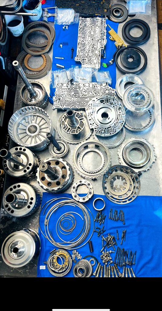 Transmission teardown laid out on the bench at Tri-Star Transmissions