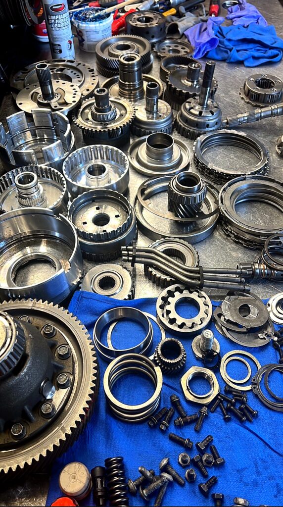 Gear sets, clutch drums and shafts laid out during a build at Tri-Star Transmissions