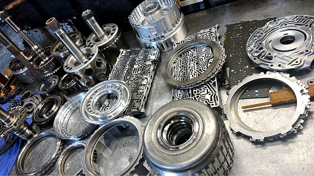 Clutch drums, valve bodies and separator plates on the bench at Tri-Star Transmissions
