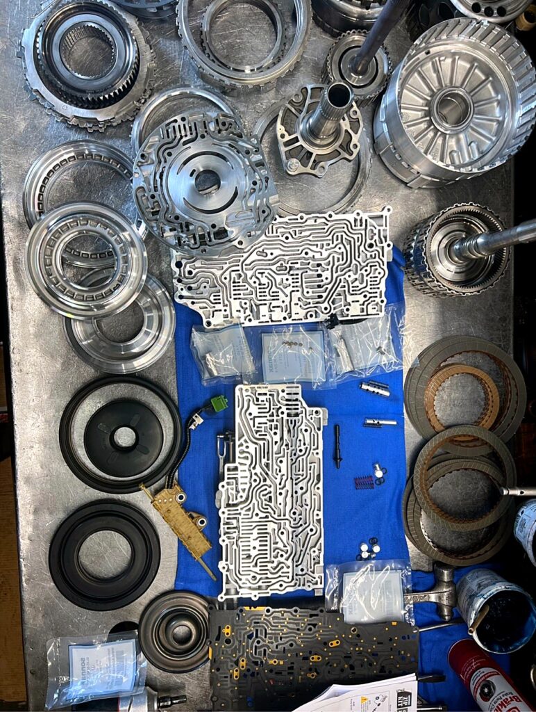 Full teardown layout with valve bodies and Sonnax parts bags at Tri-Star Transmissions