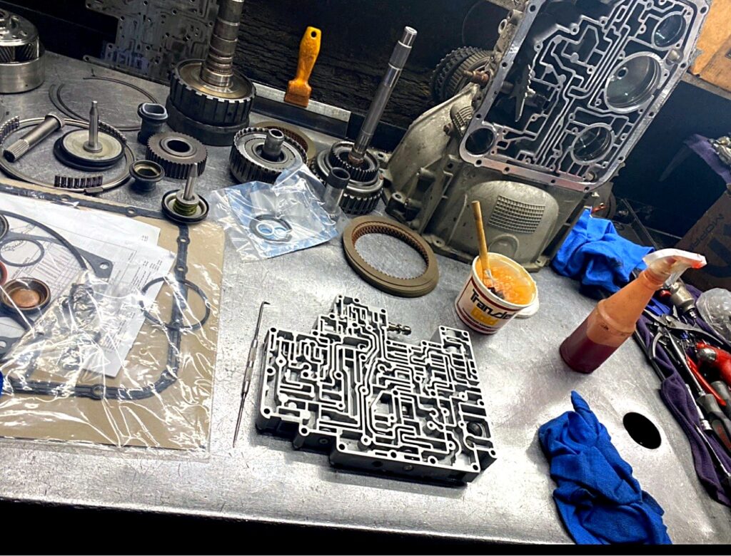 Open transmission case with valve body on the bench during a build at Tri-Star Transmissions